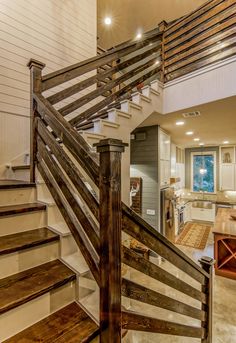 a staircase leading up to a kitchen and living room