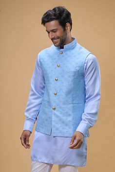 Sky blue sleeveless bundi crafted in dupion silk with sequin floret quad embroidery. Paired with a solid ice blue kurta and a white pant. - Aza Fashions Fitted Bollywood Style Sleeveless Nehru Jacket, Fitted Sleeveless Bollywood Nehru Jacket, Fitted Sleeveless Nehru Jacket With Zari Work, Designer Sleeveless Fitted Bandhgala, Fitted Sleeveless Designer Bandhgala, Fitted Sleeveless Bandhgala For Designer Wear, Fitted Sleeveless Bandhgala For Eid, Fitted Festive Vest With Zari Work, Festive Fitted Vest With Zari Work