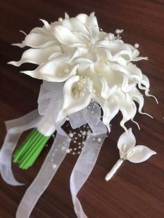 a bridal bouquet with white flowers and green stems