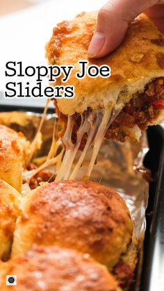 a close up of a person taking a piece of sloppy joe sliders out of a pan