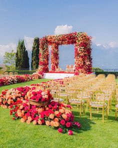 an outdoor ceremony set up with flowers and chairs