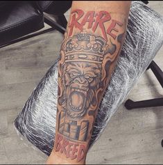 a man's leg with a tattoo on it that says rare and an angry gorilla