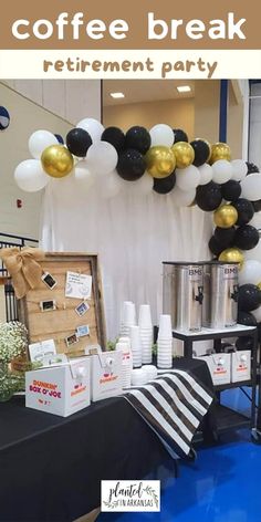 a coffee break is set up with black and white balloons