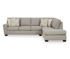 a sectional couch with pillows on it