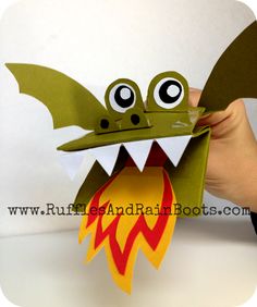 a hand holding up a paper dragon with the words chinese new year craft on it