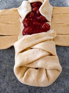 an unwrapped pastry with cherries on it