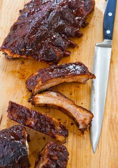 ribs on a cutting board next to a knife