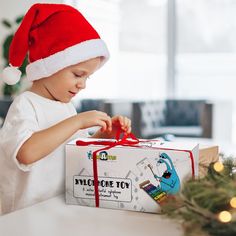 a young boy opening a christmas present box