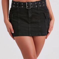 a women's black jean skirt with metal buckles on the front and side