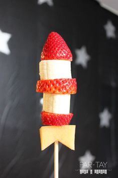 an american flag fruit skewer on a stick with cheese and strawberries in it