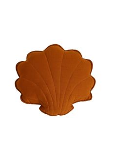 an orange scallop shaped pillow on a white background with the shape of a leaf