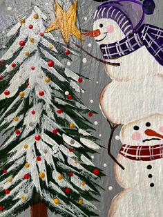 two snowmen standing next to each other in front of a christmas tree and star