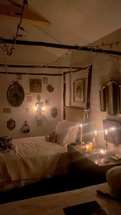 two beds in a room with lights on the ceiling and pictures on the wall above them