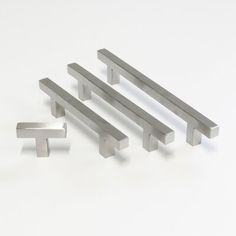 four stainless steel handles on a white background