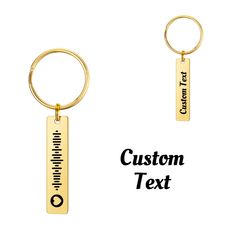 two gold key chains with the words custom text engraved on them and an image of a ruler