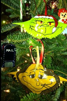 the grinch ornaments are hanging on the christmas tree