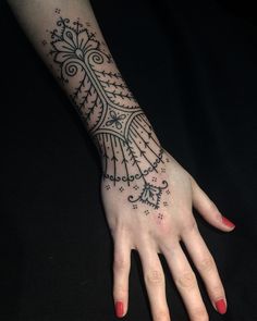 a woman's hand with a tattoo on it