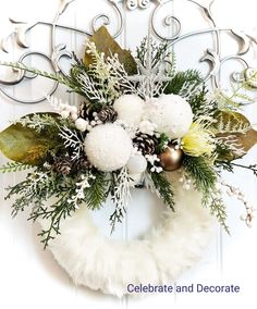 a wreath with white flowers and pine cones