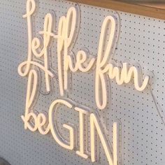 a neon sign that says life is fun and begin with it's name on the wall