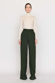 A timeless bootcut silhouette our cora pant is made from our italian twill suiting that’s blended with wool. this high-waist style features a front fly with zipper and a wide cuff at the hem. this classic forest hue invites neutrality and versatility to your wardrobe.    composition: wool twill  care: dry clean only  imported. Spring Wool Wide Leg Workwear Pants, Wool Wide Leg Pants For Workwear In Spring, Spring Wool Wide Leg Pants For Workwear, Spring Wool Dress Pants For Workwear, Fall Wide Leg Pants For Office With Straight Hem, Business Casual Wide Leg Pants For Fall, Fall Wide Leg Pants For Office, Formal Wide Leg Pants For Fall, Tailored High Waist Wool Wide Leg Pants