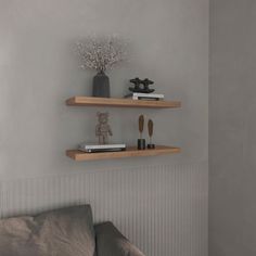 two wooden shelves on the wall above a couch