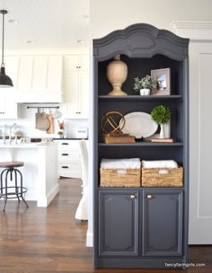 an open bookcase in the middle of a kitchen