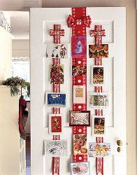 a white door decorated with red ribbon and pictures