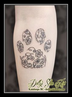 a dog's paw with flowers on it and the word dear written in black ink