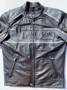 Harley-Davidson Men's Motorcycle Jacket - Black Leather Elevate your riding experience with the Harley-Davidson Men's Motorcycle Jacket. Crafted from premium quality leather, this jacket combines style, comfort, and durability to ensure you look and feel your best on and off the road. Whether you're hitting the open road, attending a casual event, or dressing up for a formal occasion, this jacket is designed to suit every moment. Product Description: *Material: Crafted from genuine leather, this Black Biker Jacket For Fall Outdoor Activities, Casual Black Biker Jacket For Outdoor Activities, Black Moto Outerwear For Outdoor, Black Riding Outerwear, Black Biker Outerwear For Outdoor, Black Biker Jacket For Outdoor Activities, Black Biker Style Outerwear For Outdoor, Black Long Sleeve Riding Outerwear, Black Long Sleeve Outerwear For Riding