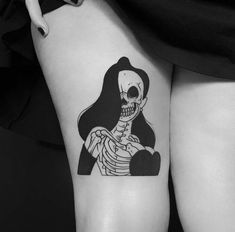 a woman with a skeleton tattoo on her thigh