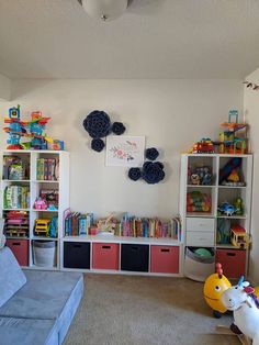 a child's playroom with toys and bookshelves