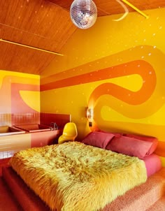 a bedroom with yellow and red walls, a bed in the center and a bathtub on the other side