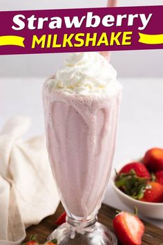 strawberry milkshake in a tall glass with whipped cream and strawberries on the side