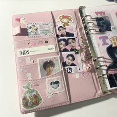 a pink planner with pictures and stickers on it's cover is open to show the inside pages