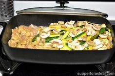 a pan filled with vegetables and mushrooms on top of a stove burner next to an oven