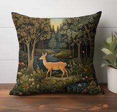 a decorative pillow with a deer in the woods