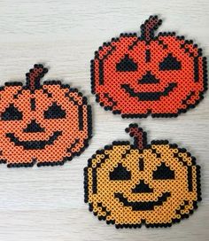 three pumpkins made out of perler beads