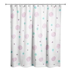 a white shower curtain with pink and green polka dots