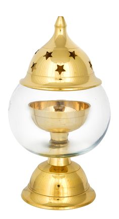 a gold and clear bowl with stars on the top is sitting on a white surface