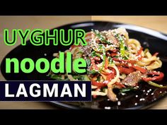 a black plate with noodles and vegetables on it that says uyghur noodle