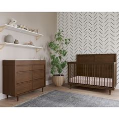 a baby's room with a crib, dresser and shelves in the corner