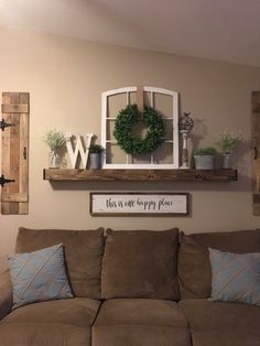 a living room filled with furniture and decor on top of a wooden shelf above a window