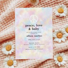 the peace love and baby card is surrounded by daisies on top of a blanket