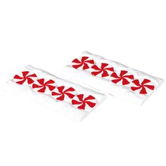 two red bows on white pillow cases sitting next to each other in front of a white background