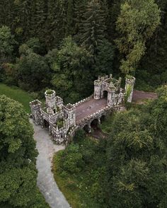 an aerial view of a castle in the woods