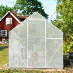 a house with a greenhouse in front of it