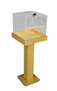 a clear plastic box sitting on top of a wooden stand with the word prayer request printed on it