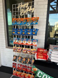 a happy birthday display in front of a store window with candy bars on the stick