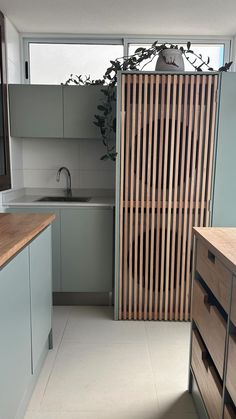 an empty kitchen with wooden slats on the wall