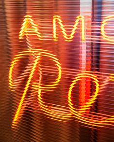 blurry photograph of the word made with neon lights